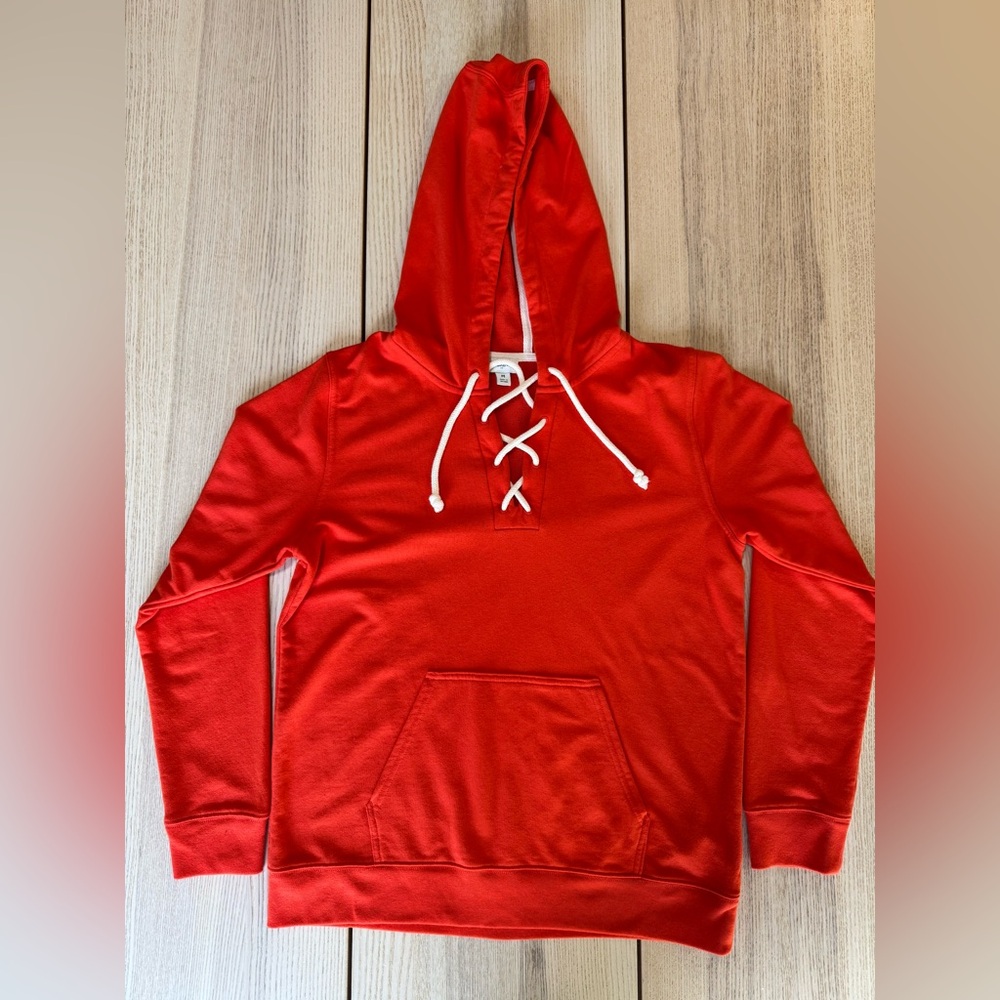 J.Crew women’s orange hoodie, size M, with a lace-up front and kangaroo pocket.
